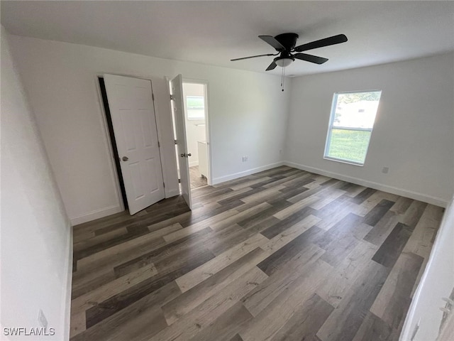 spare room with ceiling fan and dark hardwood / wood-style flooring