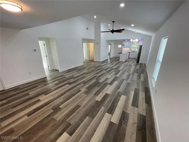 unfurnished living room with ceiling fan, dark hardwood / wood-style flooring, and high vaulted ceiling