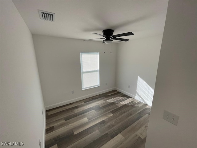 unfurnished room featuring ceiling fan and dark wood-type flooring