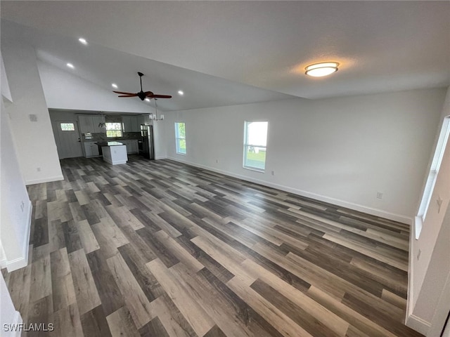 unfurnished living room featuring ceiling fan, dark hardwood / wood-style flooring, and lofted ceiling