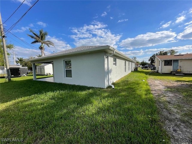 view of side of home with a yard