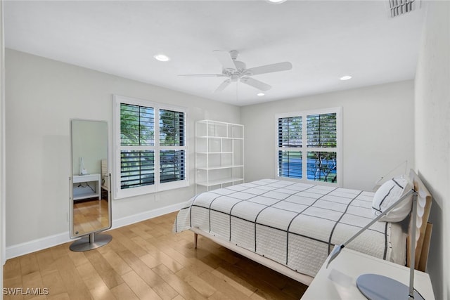 bedroom with hardwood / wood-style floors and ceiling fan