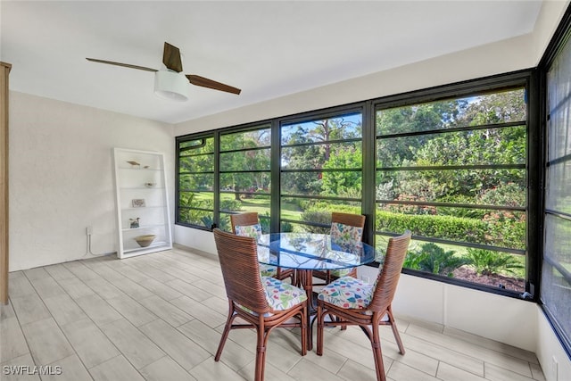 sunroom featuring ceiling fan