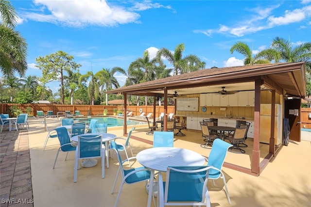 view of patio / terrace featuring ceiling fan and a community pool