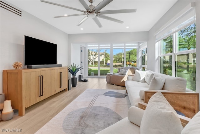 living room featuring ceiling fan and light wood-type flooring