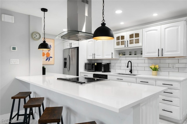 kitchen featuring white cabinetry, sink, stainless steel appliances, kitchen peninsula, and island exhaust hood