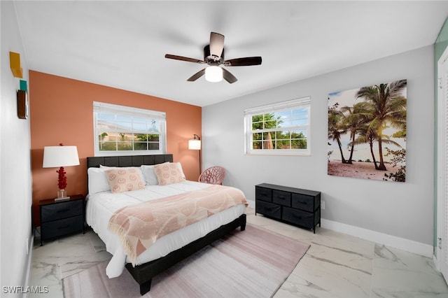 bedroom with ceiling fan and multiple windows