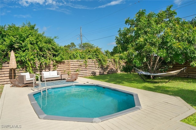 view of pool featuring a lawn, a deck, and an outdoor hangout area