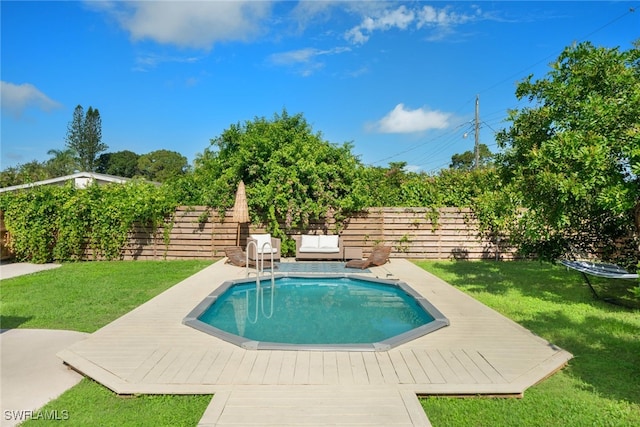 view of swimming pool featuring a wooden deck and a yard