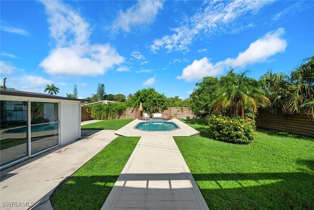 view of pool with a lawn