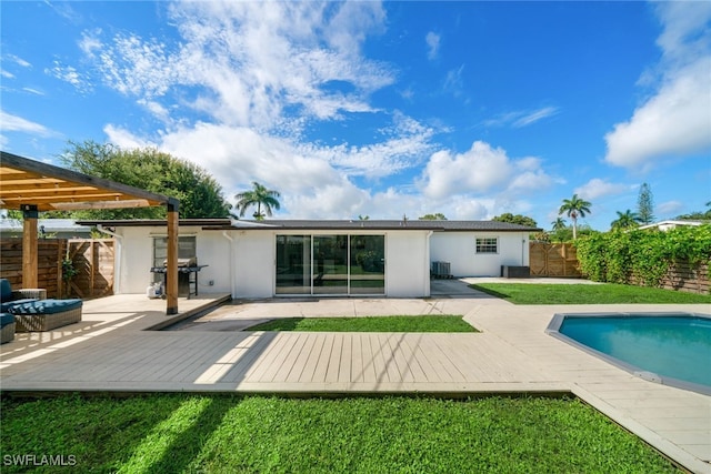 back of property with a pergola, a pool side deck, outdoor lounge area, central AC unit, and a yard