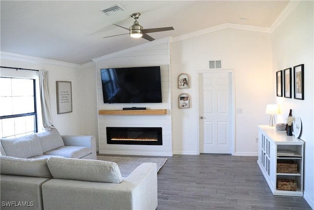 living room with dark hardwood / wood-style flooring, ornamental molding, a fireplace, and vaulted ceiling