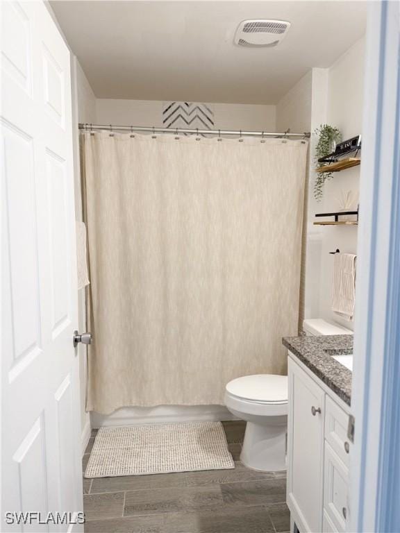 bathroom featuring vanity, toilet, and wood-type flooring