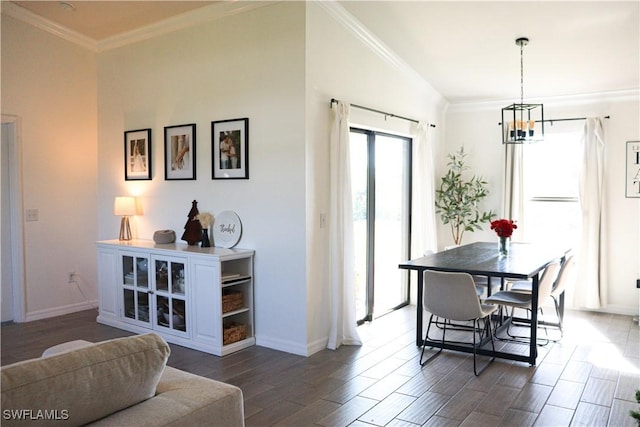 dining space featuring dark hardwood / wood-style flooring, ornamental molding, and an inviting chandelier