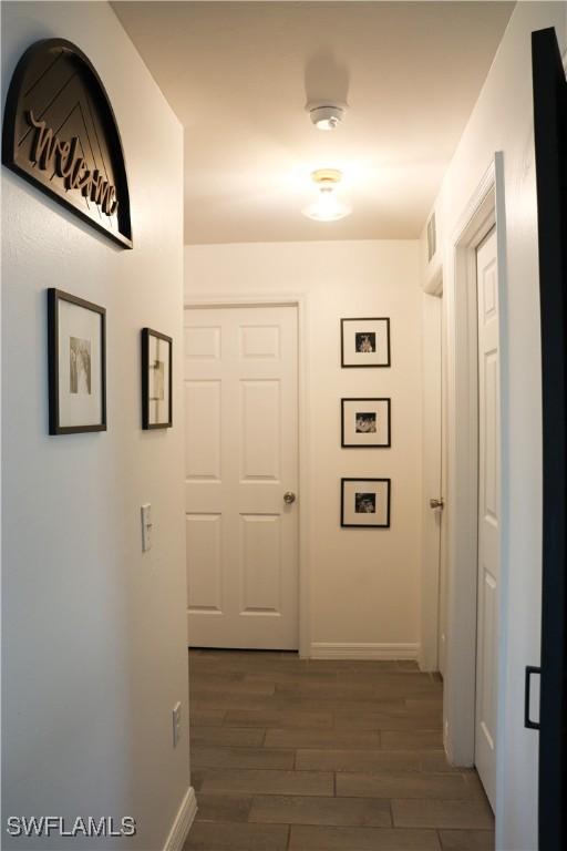 corridor with dark hardwood / wood-style floors