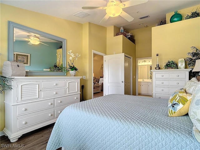 bedroom featuring ceiling fan, connected bathroom, and dark hardwood / wood-style flooring