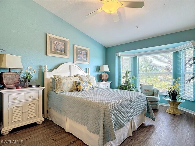 bedroom featuring ceiling fan, vaulted ceiling, and dark hardwood / wood-style flooring