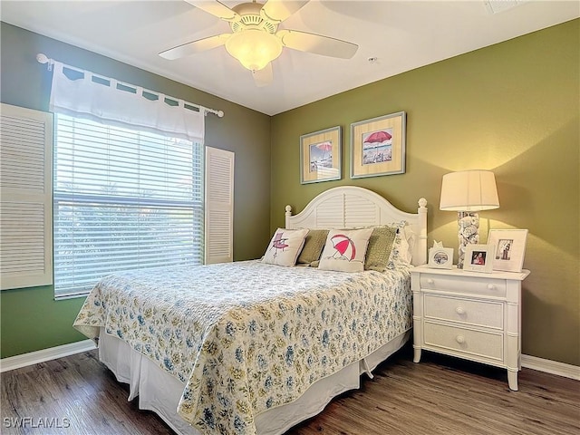 bedroom with dark hardwood / wood-style floors and ceiling fan