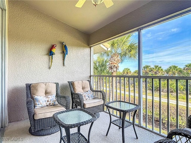 sunroom / solarium featuring ceiling fan