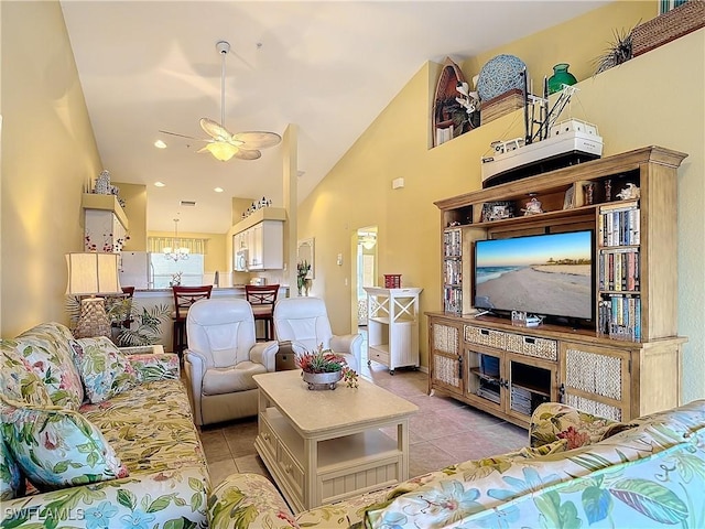 living room featuring light tile patterned floors, ceiling fan with notable chandelier, and high vaulted ceiling