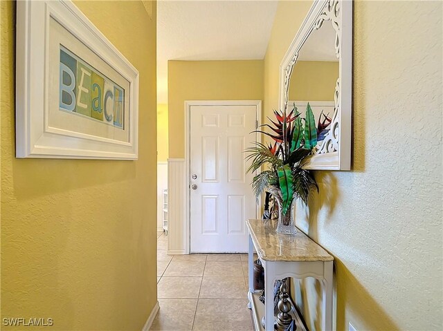 doorway to outside with light tile patterned floors