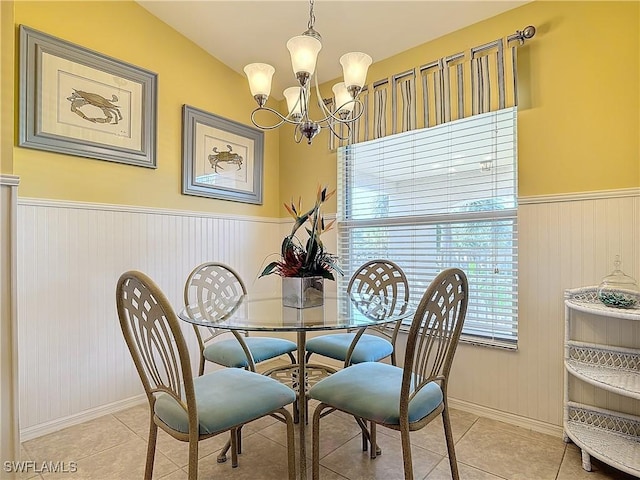 tiled dining area with an inviting chandelier