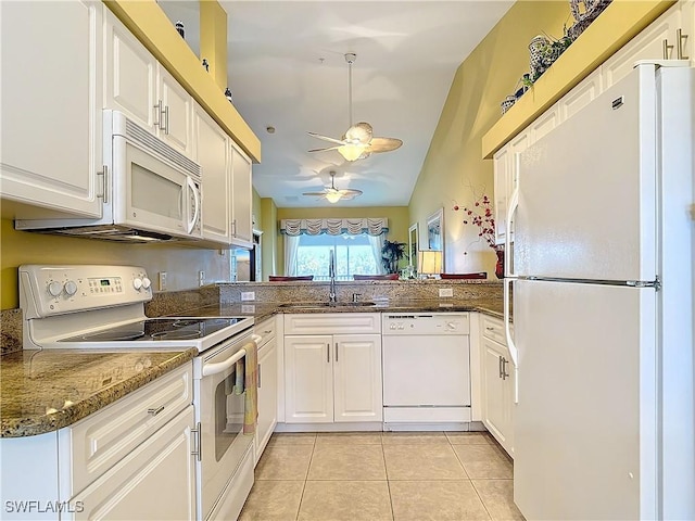 kitchen with sink, white appliances, kitchen peninsula, and white cabinets