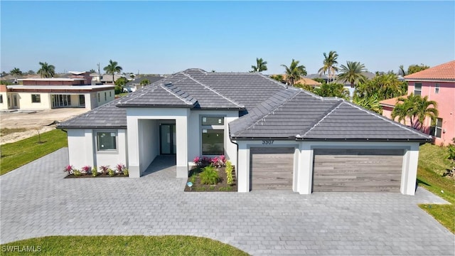 3307 NW 3rd St, Cape Coral, FL 33993 - ranch-style house with a garage, decorative driveway, and stucco siding