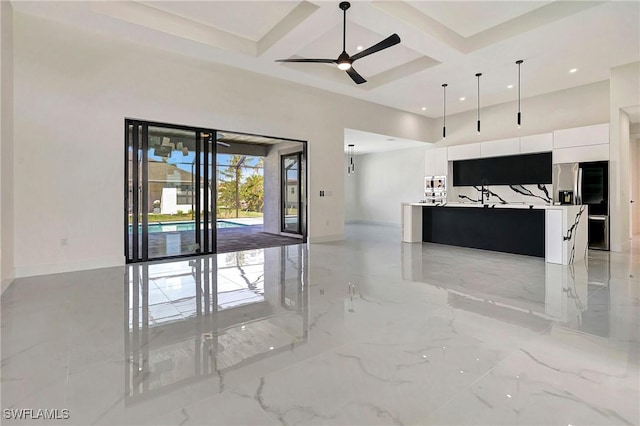 interior space featuring beamed ceiling, ceiling fan, and coffered ceiling