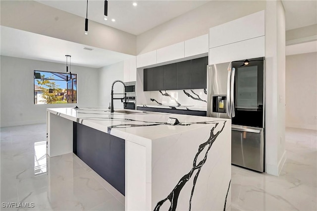 kitchen with a spacious island, hanging light fixtures, white cabinetry, stainless steel appliances, and a chandelier