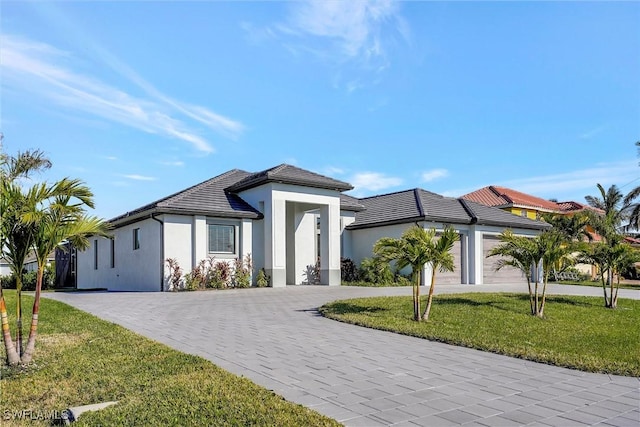 view of front of house with a front yard and a garage