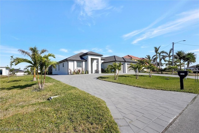 view of front of house featuring a garage and a front lawn