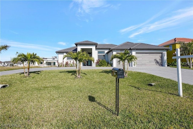 3307 NW 3rd St, Cape Coral, FL 33993 - view of front of property with driveway, stucco siding, an attached garage, and a front yard