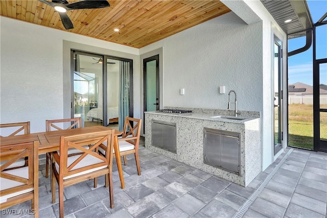3307 NW 3rd St, Cape Coral, FL 33993 - interior space with stainless steel gas cooktop, stone tile floors, a textured wall, a sink, and wooden ceiling