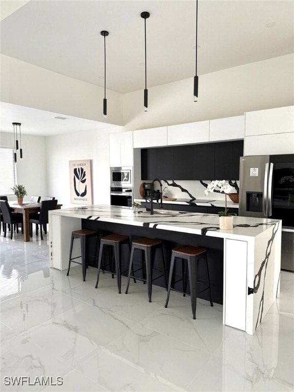3307 NW 3rd St, Cape Coral, FL 33993 - kitchen with stainless steel appliances, marble finish floor, white cabinetry, and modern cabinets