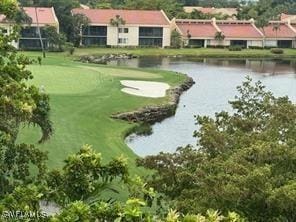 view of home's community with a yard and a water view