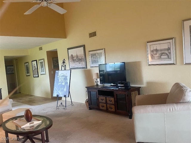 carpeted living room with ceiling fan