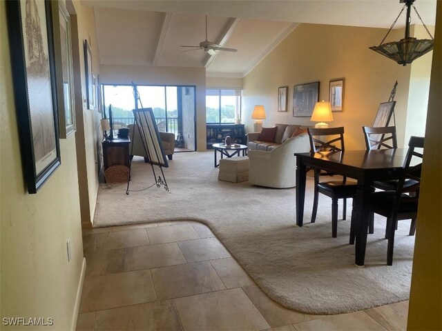 carpeted living room with lofted ceiling with beams and ceiling fan