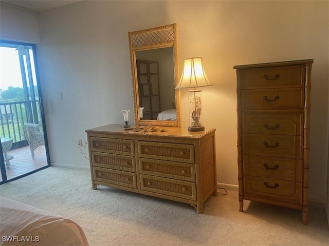 bedroom featuring access to outside, baseboards, and light colored carpet