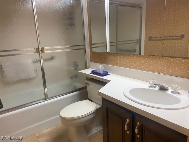 full bathroom with tile patterned flooring, vanity, toilet, and enclosed tub / shower combo