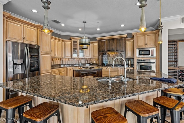 kitchen featuring a large island, decorative light fixtures, and appliances with stainless steel finishes