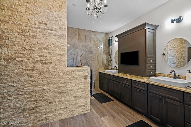 bathroom with vanity, a chandelier, and wood-type flooring