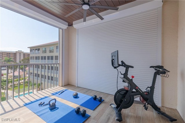 exercise area with ceiling fan, wood-type flooring, and wood ceiling