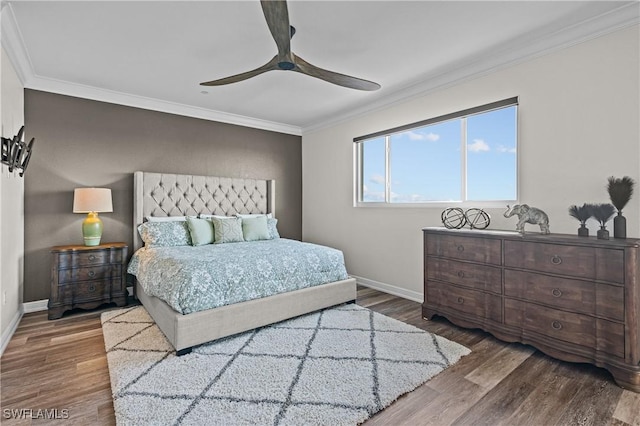 bedroom with hardwood / wood-style floors, ceiling fan, and ornamental molding