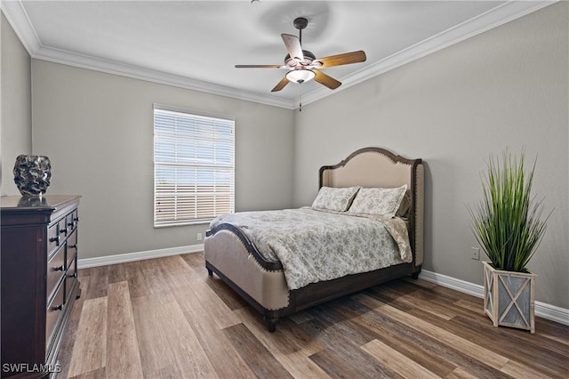 bedroom with dark hardwood / wood-style floors, ceiling fan, and ornamental molding