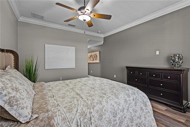 bedroom featuring hardwood / wood-style flooring, ceiling fan, and crown molding