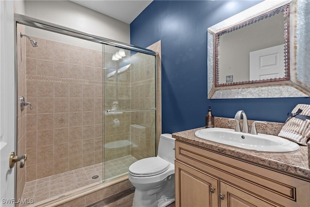 bathroom featuring vanity, toilet, wood-type flooring, and walk in shower