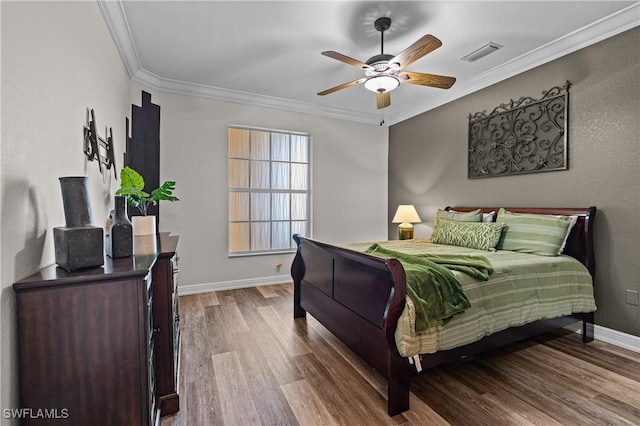 bedroom featuring ceiling fan, crown molding, and wood-type flooring