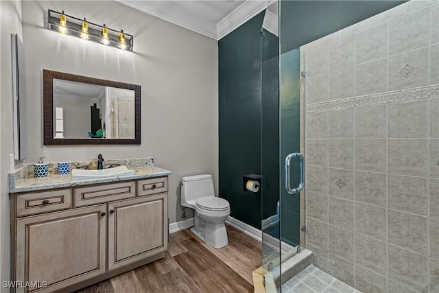 bathroom featuring hardwood / wood-style floors, vanity, crown molding, toilet, and a shower with shower door