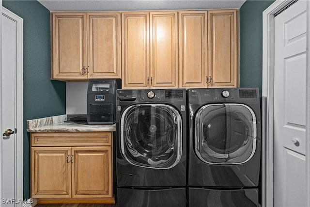 washroom with washing machine and dryer and cabinets